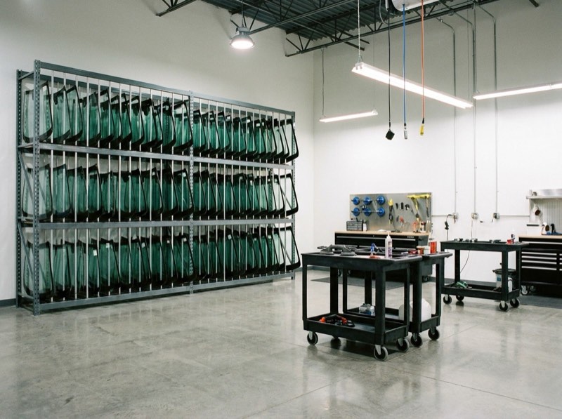 Auto glass shop interior in Harrisburg, PA with windshields organized on a storage rack
